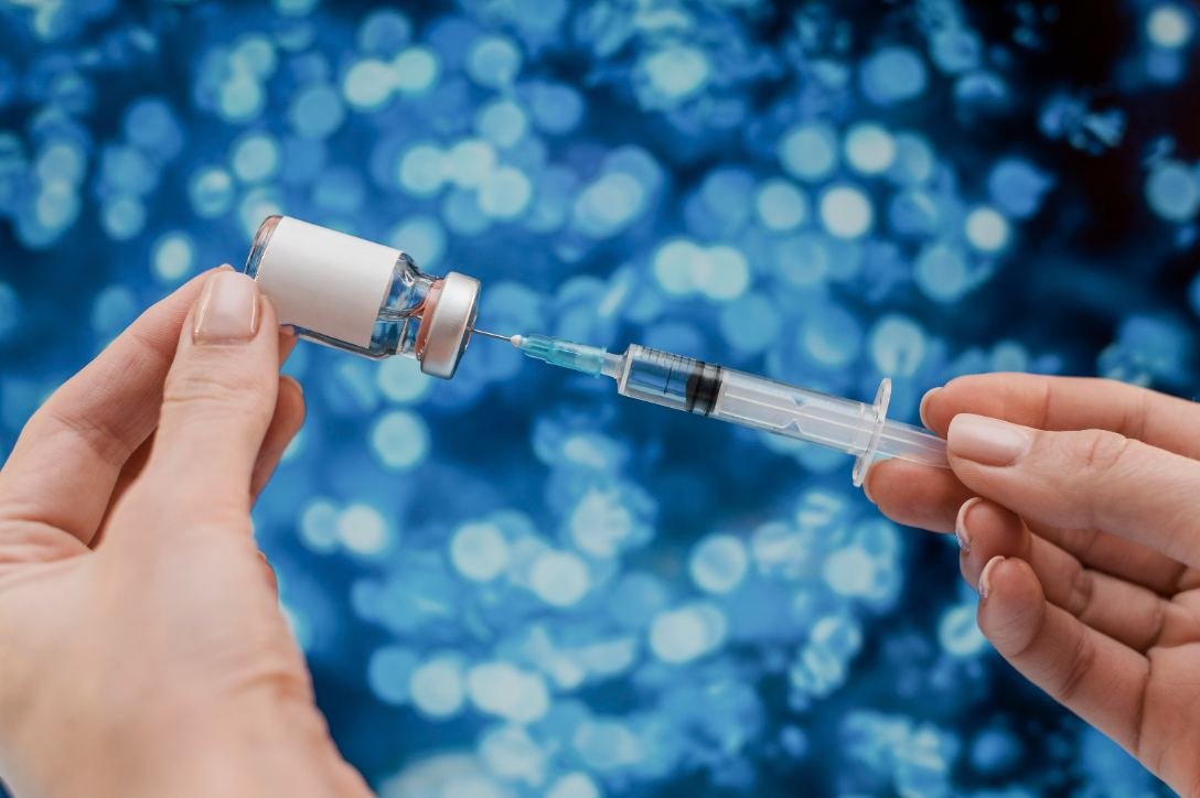 hand filling syringe with vaccine peptide